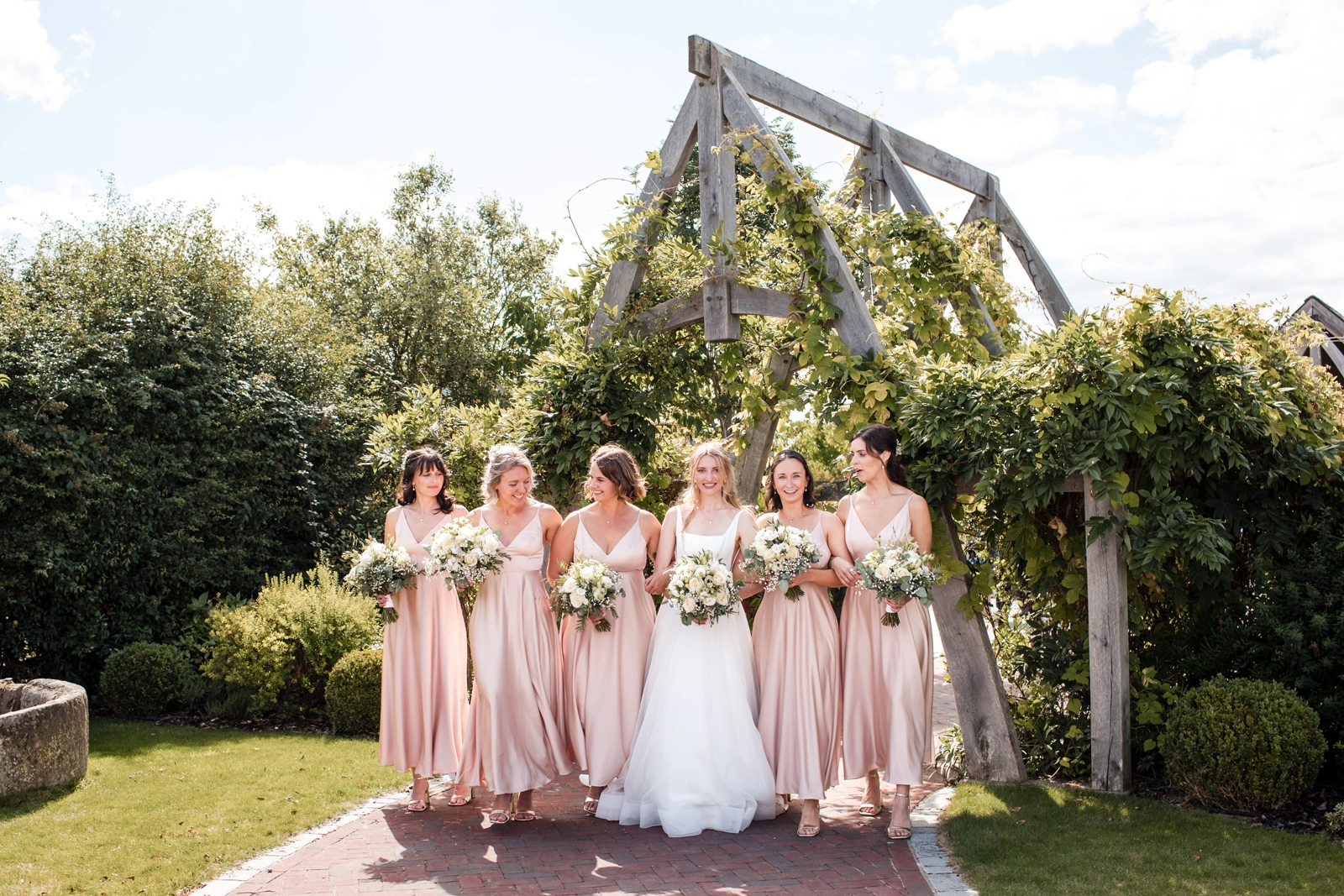 Bridesmaids infront of the entrance arch