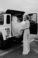 Bride getting into Land Rover