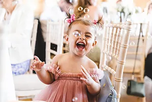 A bridesmaid playing with bubbles